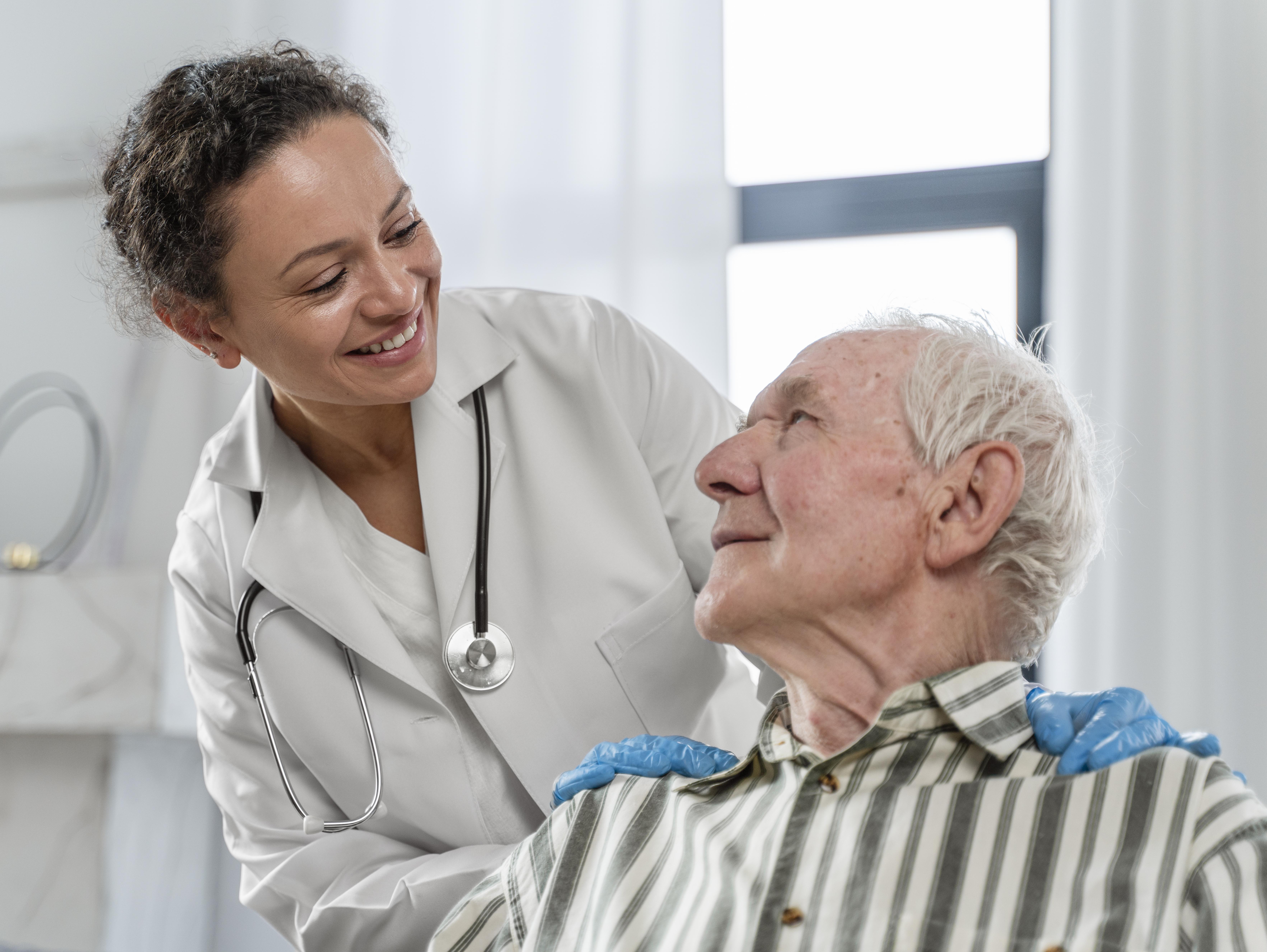 Caring professional assisting an elderly person